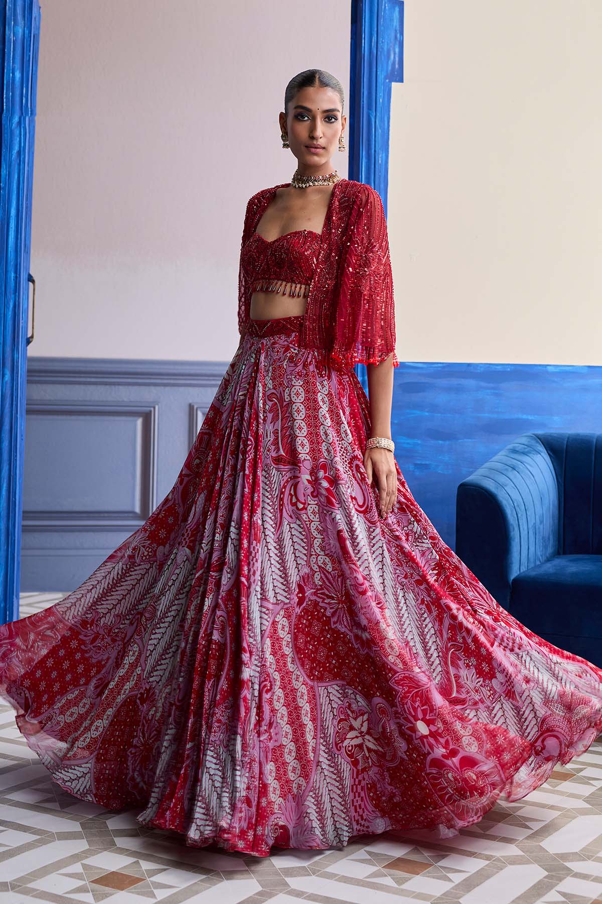 RED EMBROIDERED BLOUSE WITH TASSEL CAPE JACKET & FLORAL LEHENGA SET