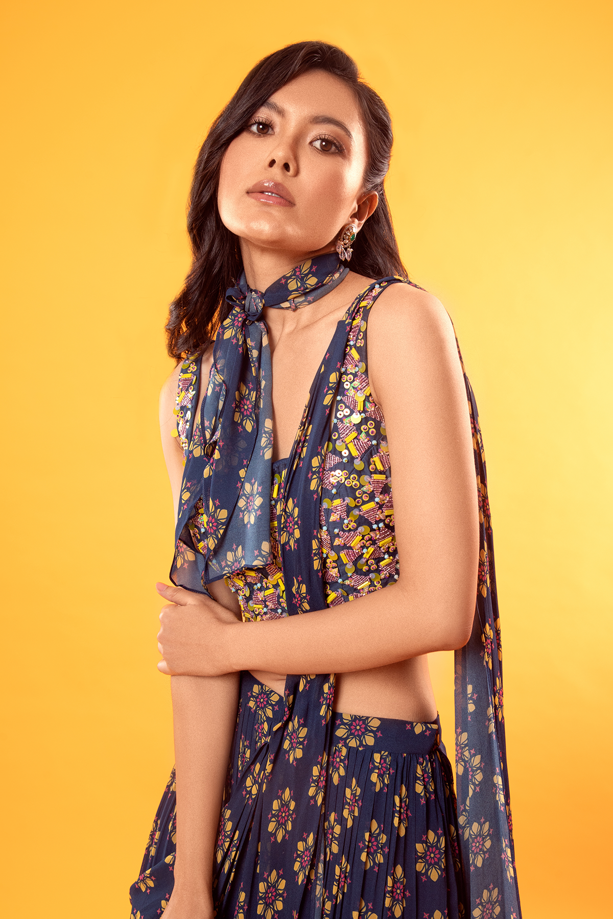 BLUE TRIGONAL EMBROIDERED BLOUSE WITH FLORAL PRINTED TIERED SKIRT SAREE & EMBROIDERED POTLI BAG