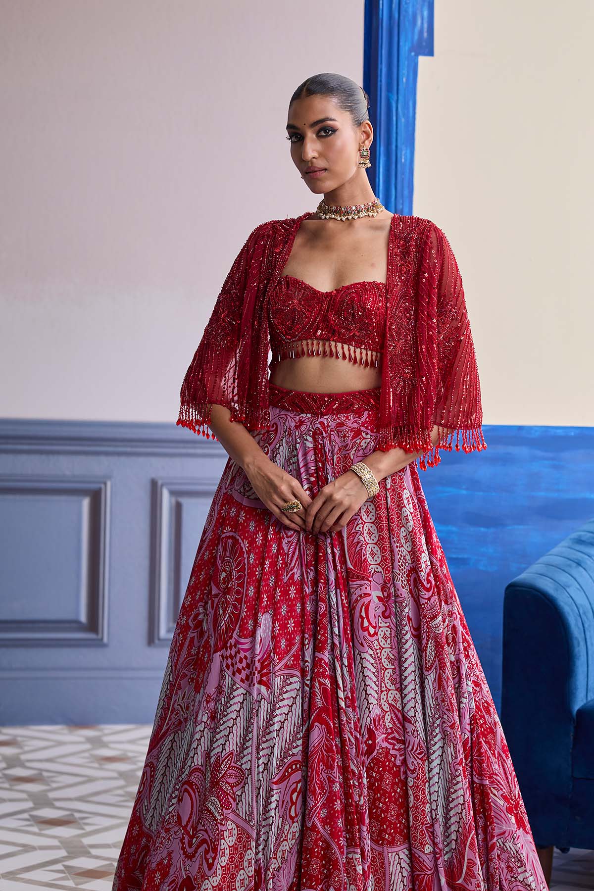 RED EMBROIDERED BLOUSE WITH TASSEL CAPE JACKET & FLORAL LEHENGA SET