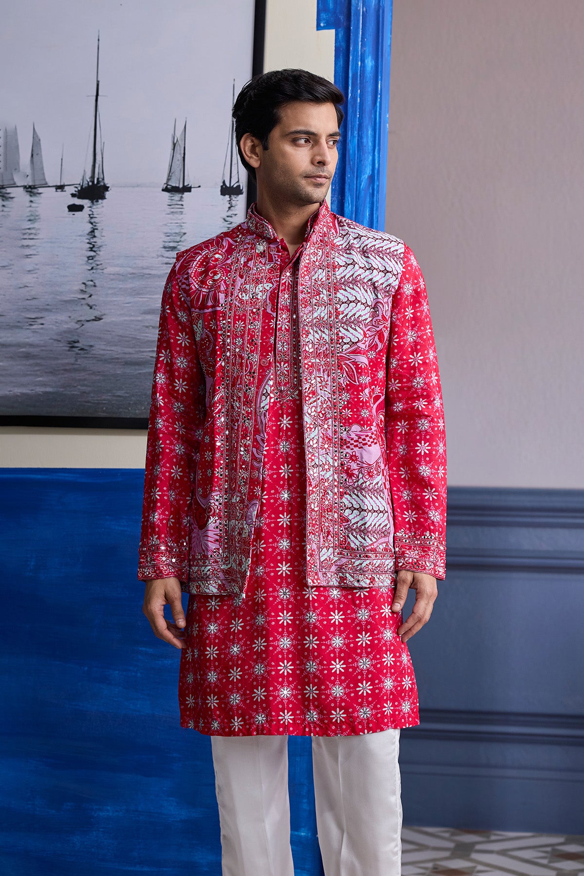 RED PRINT HIGHLIGHTED  KURTA WITH PRINT EMBROIDERED BUNDI AND IVORY PANTS