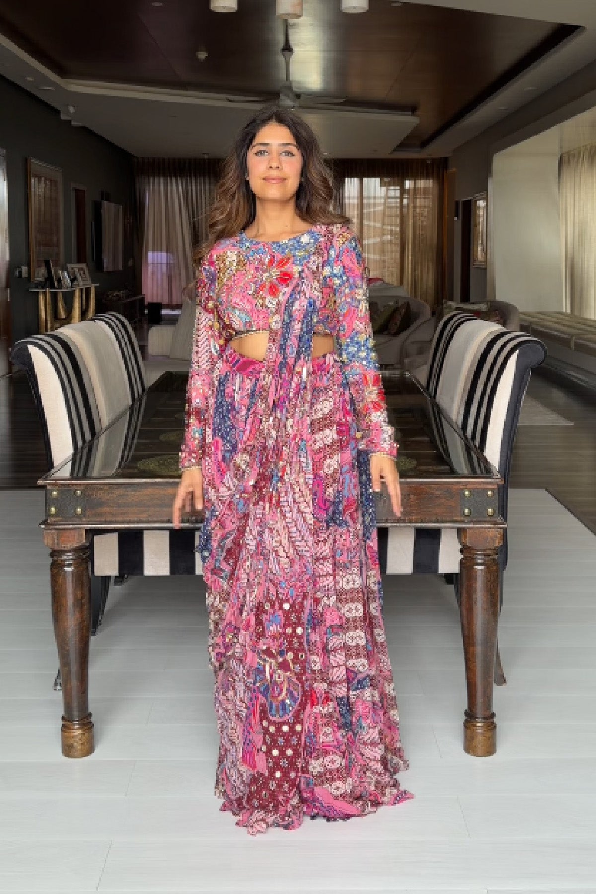 MEHEK KEJRIWAL IN FUCHSIA FLORAL BLOUSE WITH DRAPE TIERED SAREE SKIRT SET