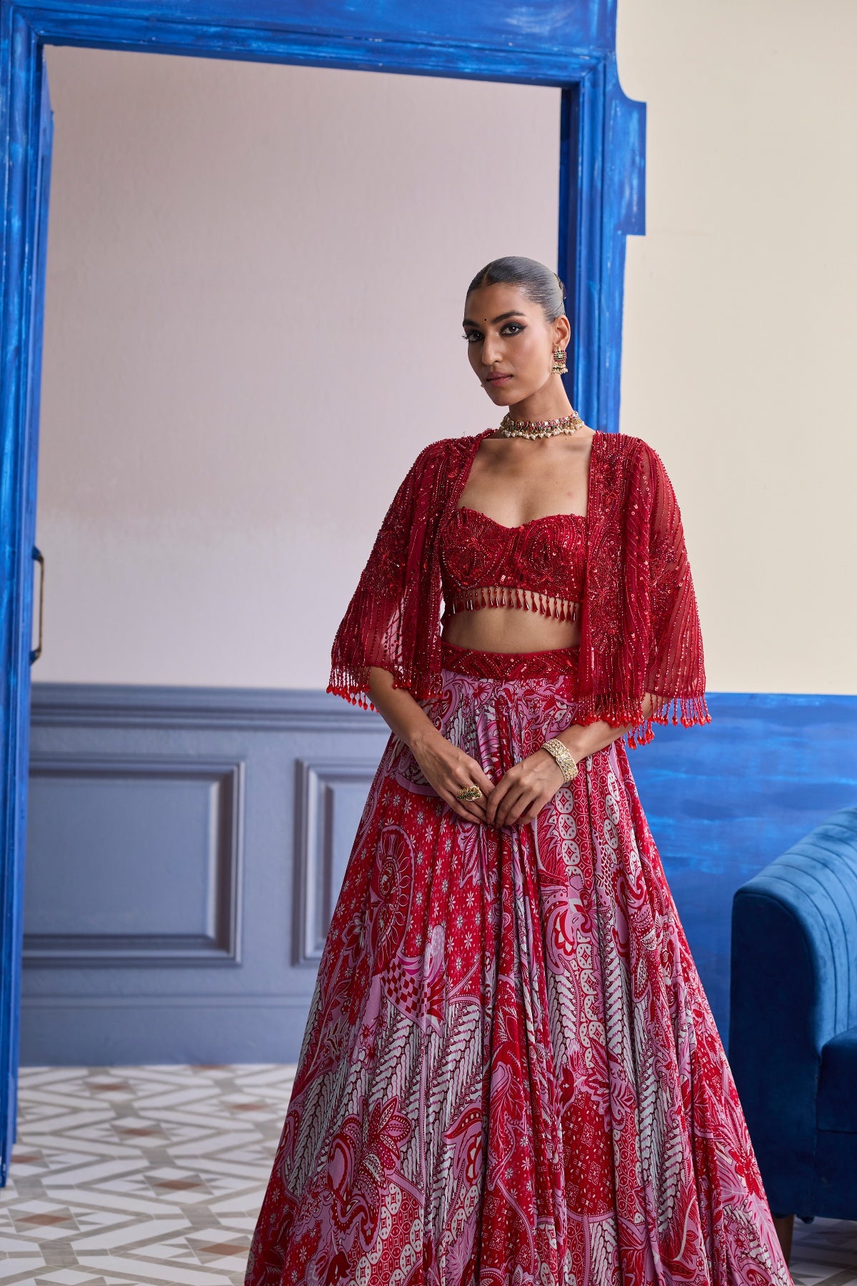 RED EMBROIDERED BLOUSE WITH TASSEL CAPE JACKET & FLORAL LEHENGA SET
