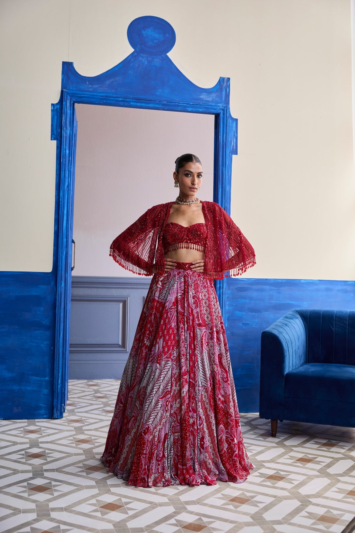 RED EMBROIDERED BLOUSE WITH TASSEL CAPE JACKET & FLORAL LEHENGA SET