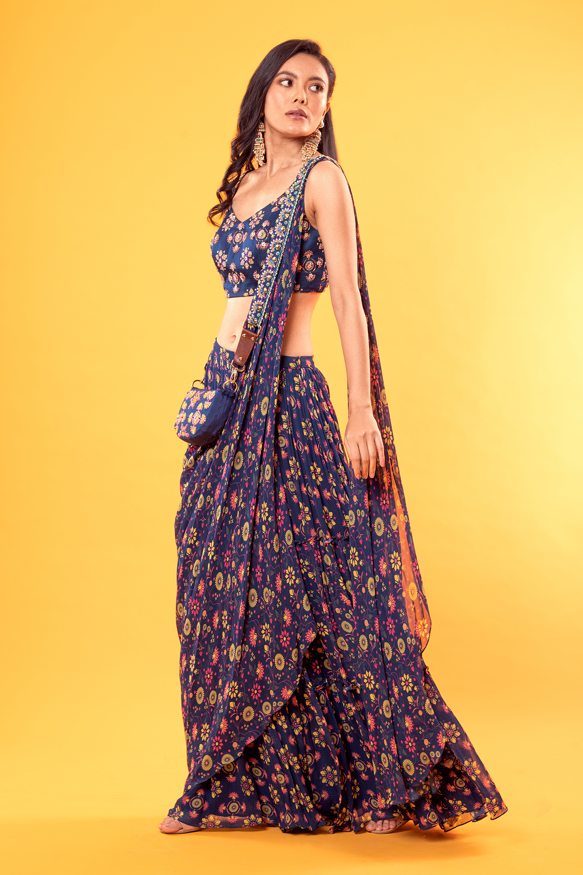 BLUE MIX BUTTA PRINTED V NECK BLOUSE WITH JAAL PRINTED TIERED SKIRT SAREE & POTLI BAG