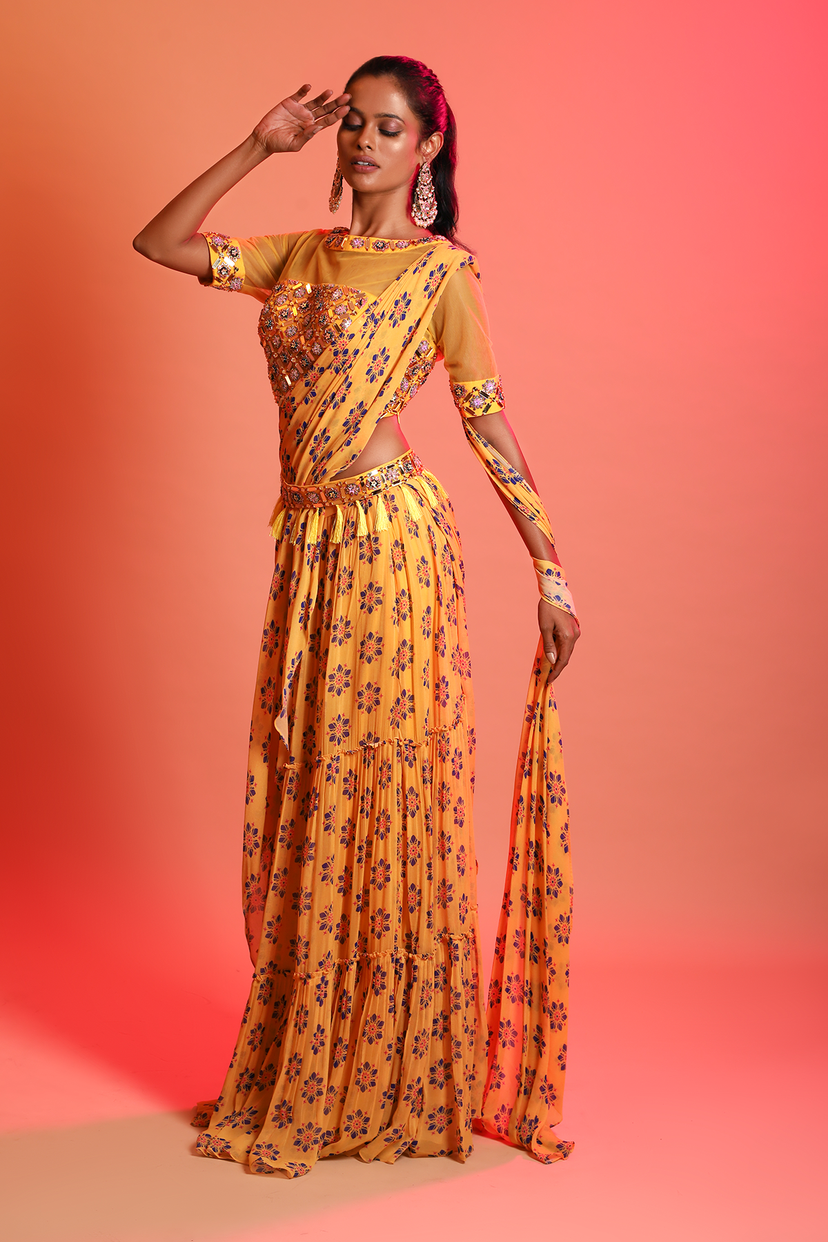 MUSTARD ARYLIC EMBROIDERED BLOUSE & MUSTARD FLORAL PRINTED TIERED SKIRT SAREE WITH EMBROIDERED TASSEL BELT